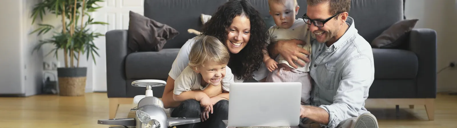 a person sitting on a couch using a laptop