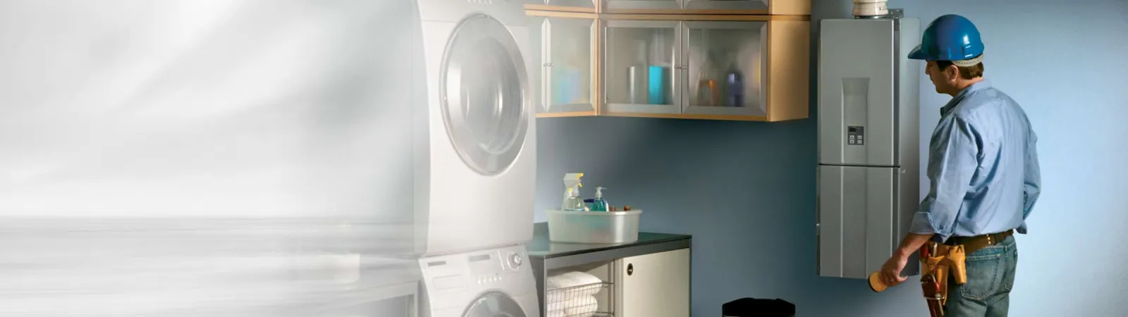 a man standing in front of a tankless water heater