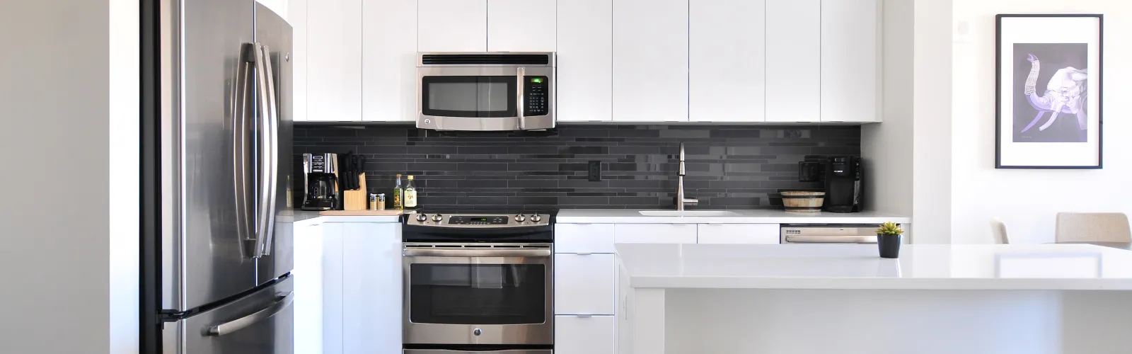 a kitchen with a bar stool and a refrigerator