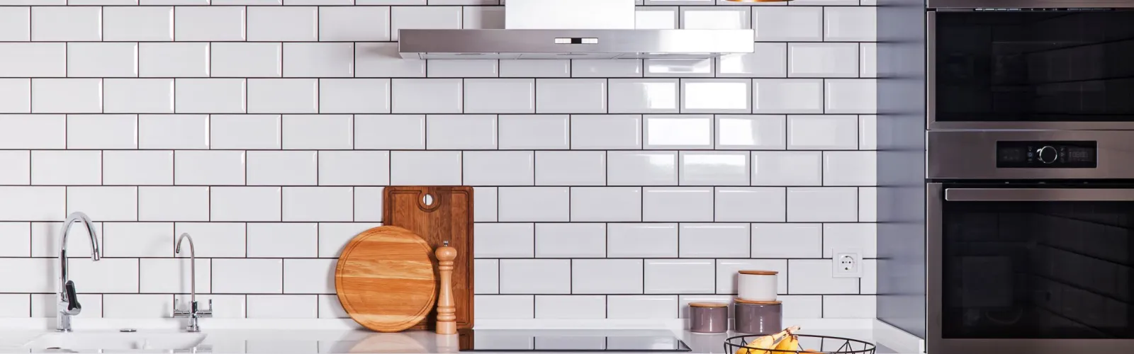 a kitchen with a white brick wall