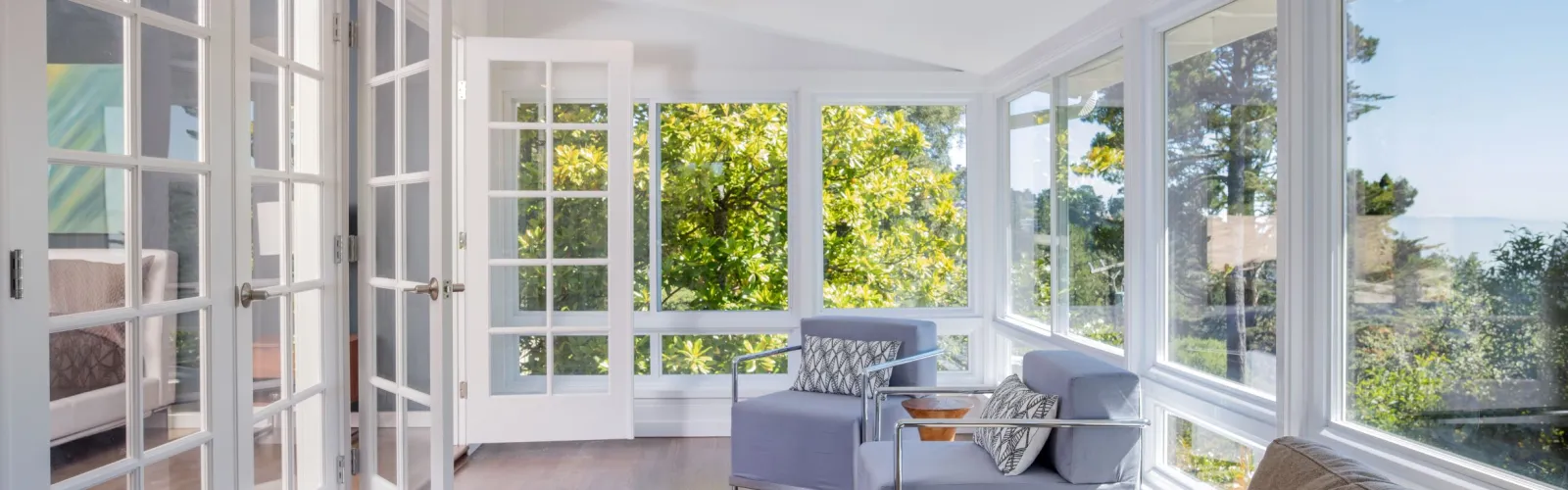 a living room with a white couch and a mirror