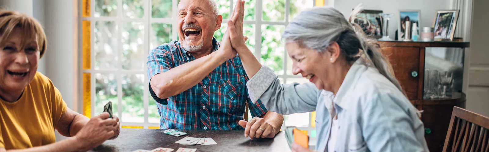 a group of people sitting around a table playing a board game