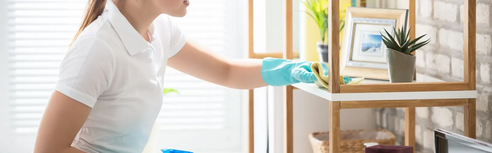 a woman in gloves holding a blue container