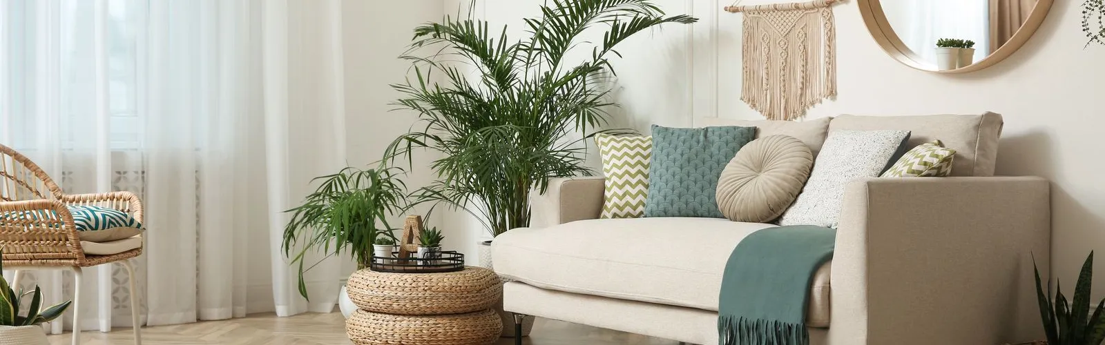 a living room with a white couch and a mirror