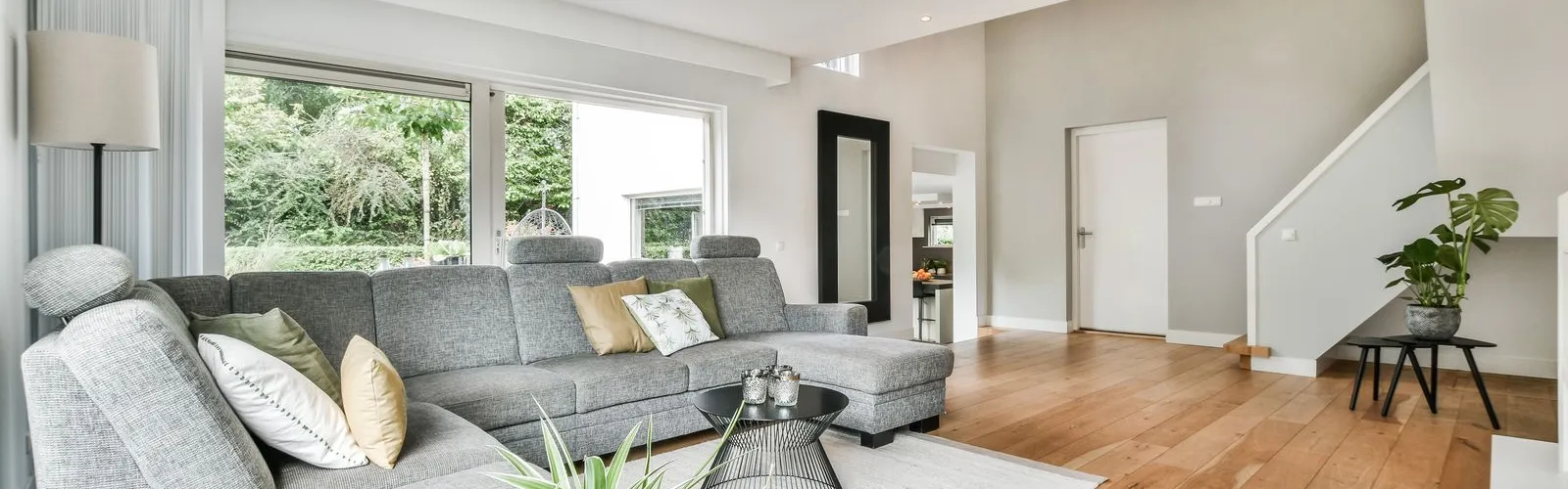 a living room with a large glass coffee table and a large window