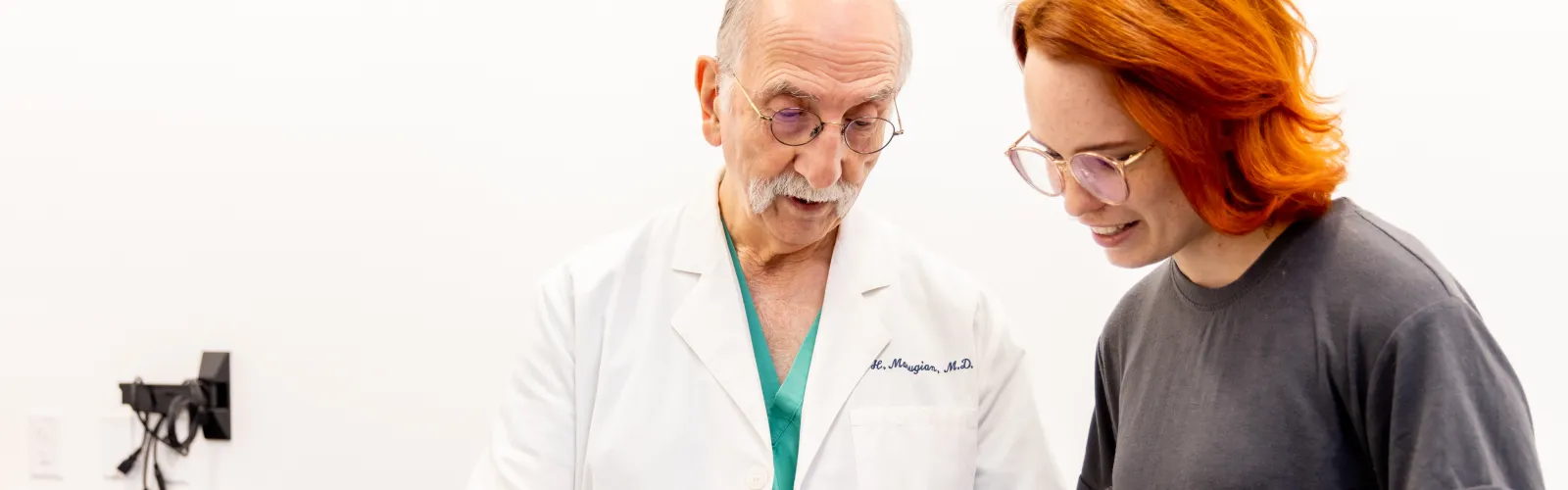 a doctor and a person looking at a tablet
