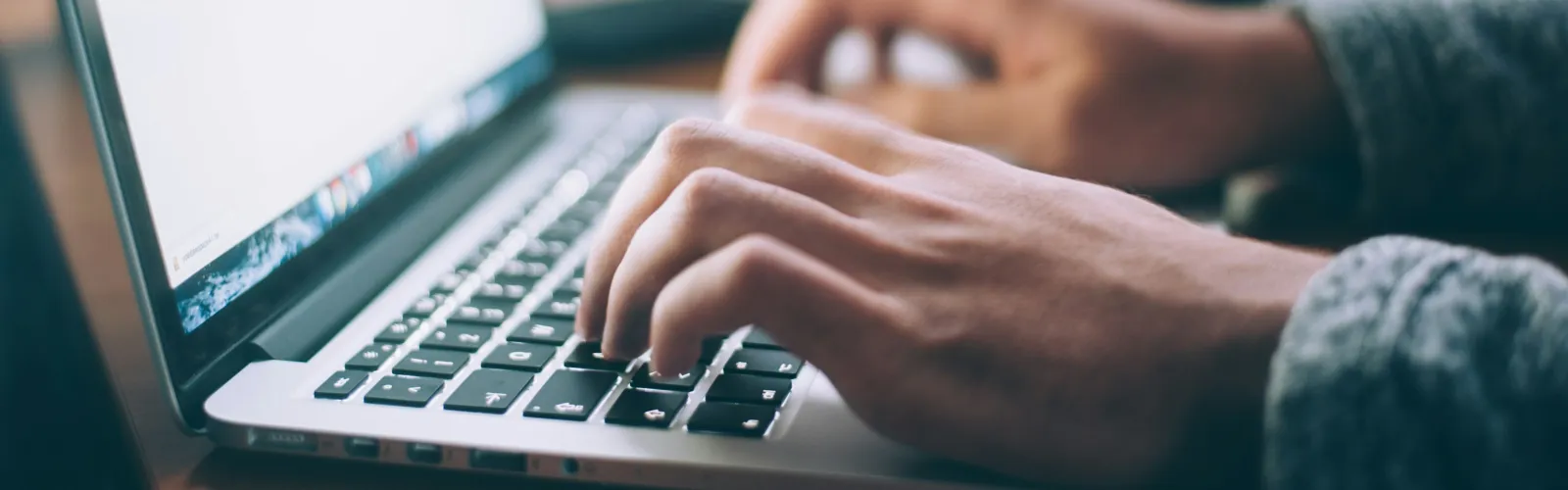 a person typing on a laptop