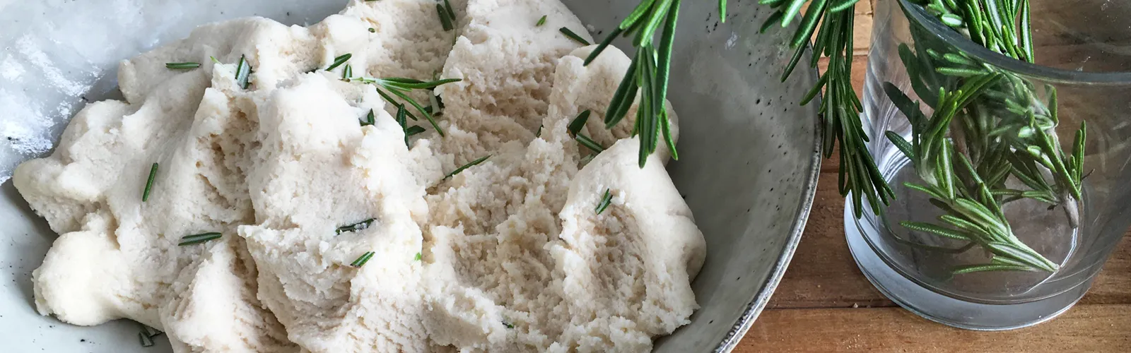 a bowl of dough and herbs