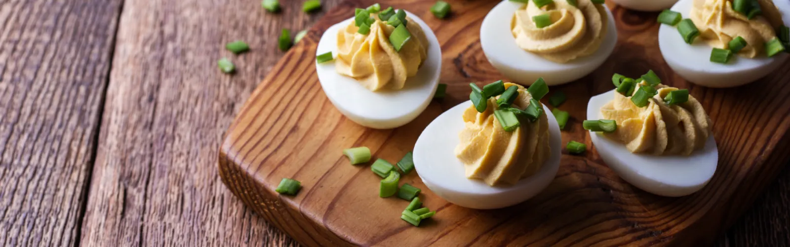 a plate of deviled eggs on a wooden table