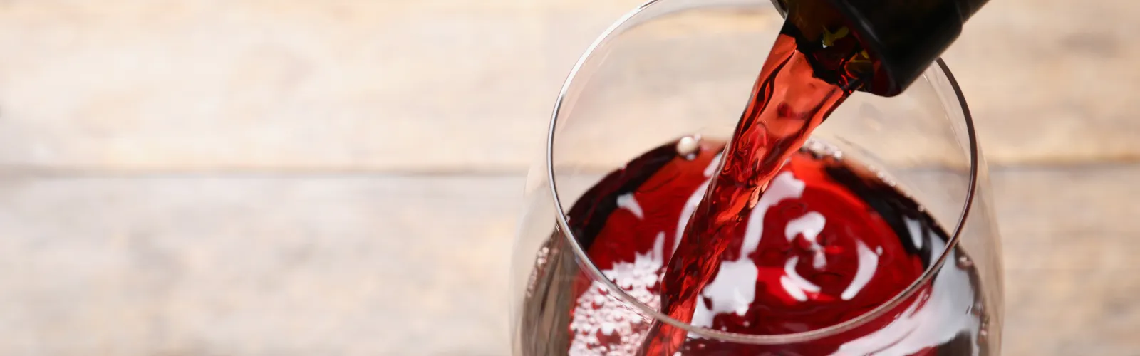 a close up of a glass of red wine