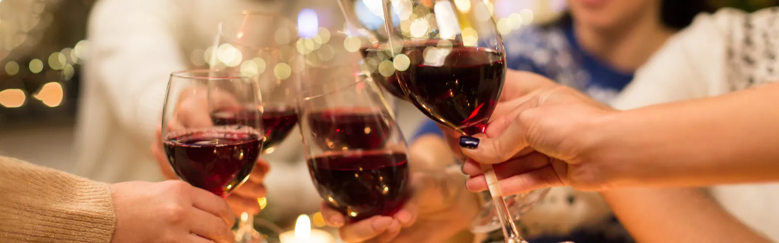 a woman sitting at a table with wine glasses
