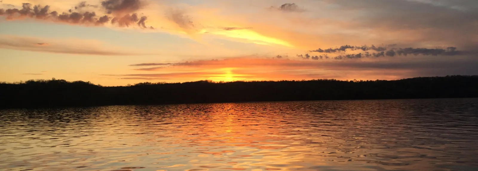 a person standing next to a lake