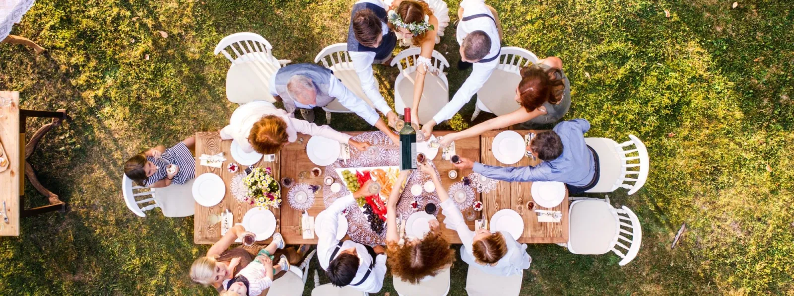 a group of people sitting around a table with food on it