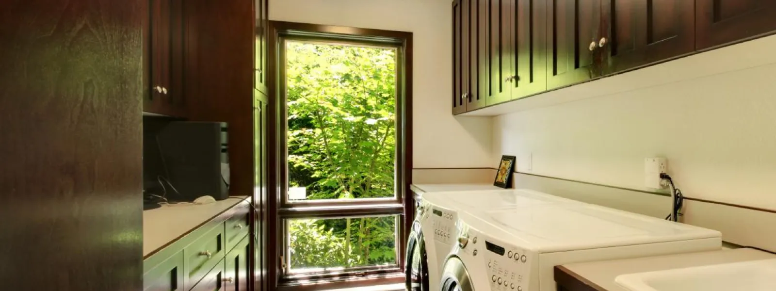 a laundry room with a sink and a window