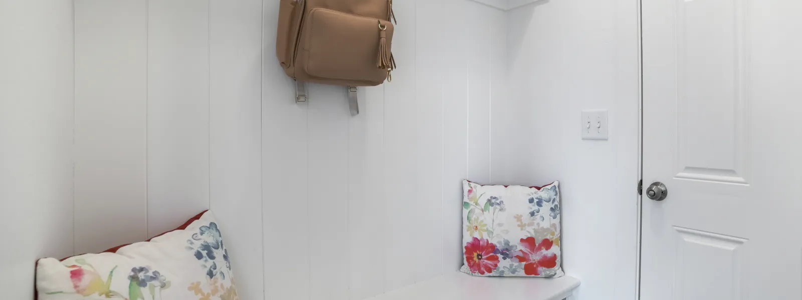 a purse on a wall in a mud room