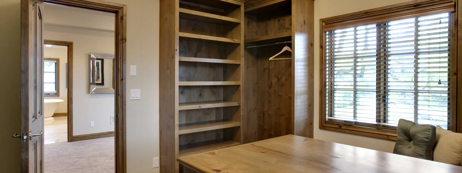 a walk-in with a table and wood shelves