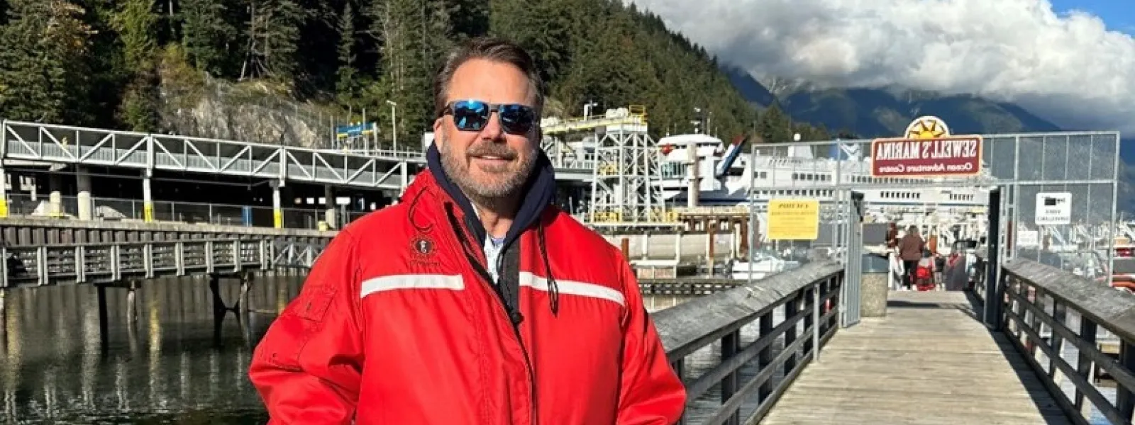 Business professionals attending a training seminar in a modern conference room with a presenter and projected slides.