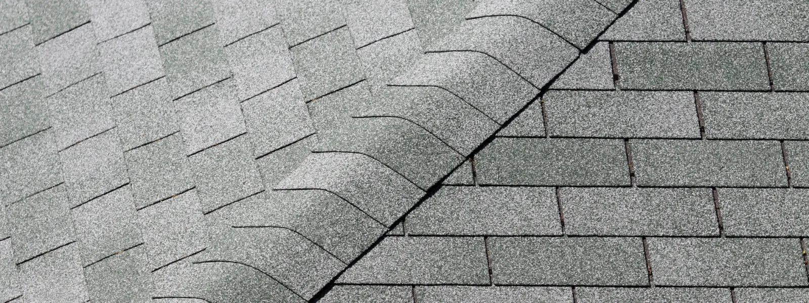 a close up of a brick building with 3 tab shingles
