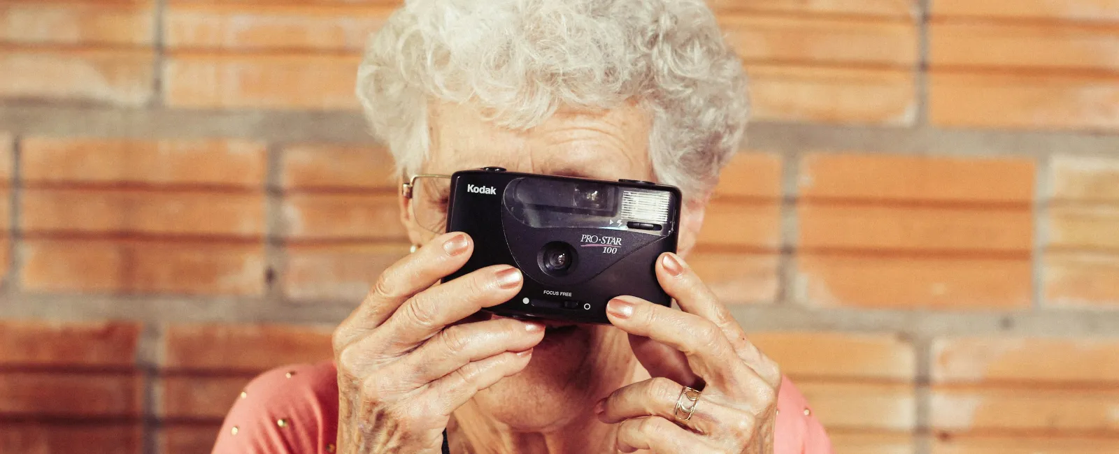 an older woman holding a camera