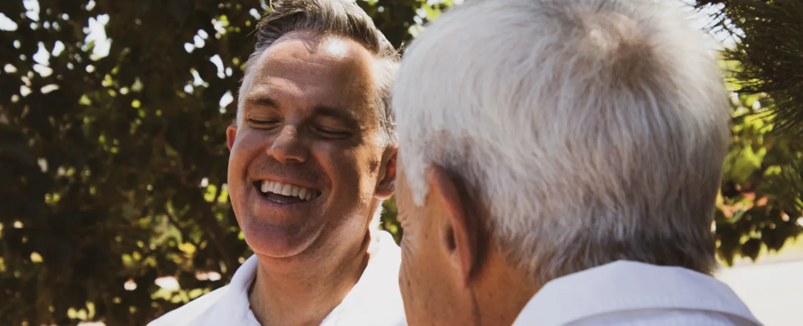 a man with his head on another man's shoulder