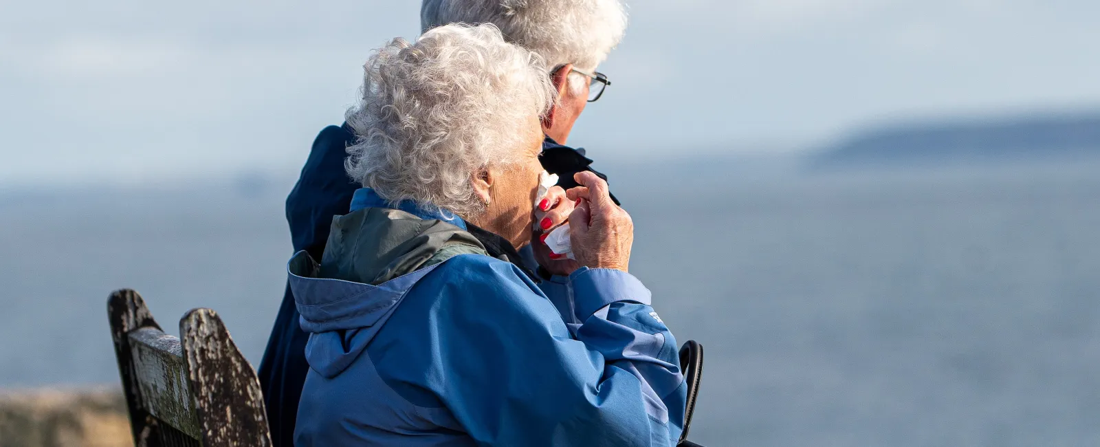 an older couple sitting on a bench