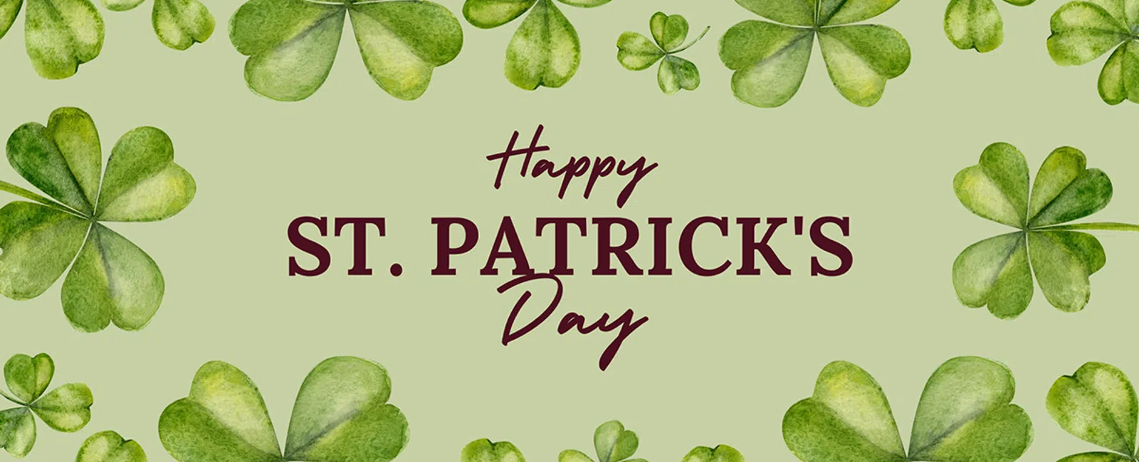 Green watercolor shamrocks framing Happy St. Patrick's Day text on a light green background for festive design.