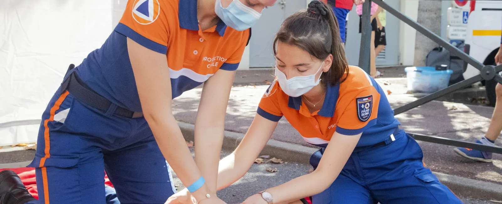 a group of people in blue jumpsuits working on a patient