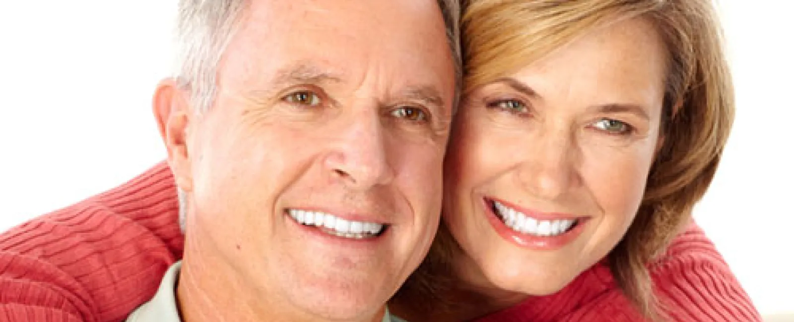 Happy middle-aged couple smiling and embracing each other with a white background