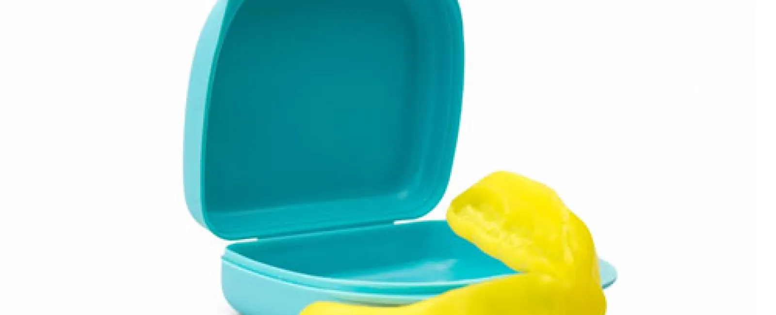 Yellow mouthguard displayed in front of open blue plastic storage case on white background