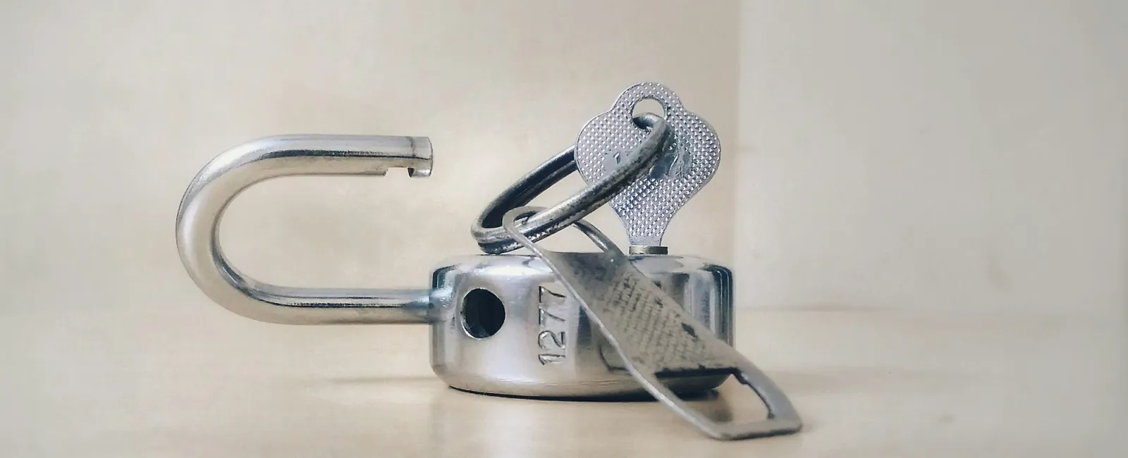 Man cutting rope tying large ball at cliff edge causing break and risk of falling down.