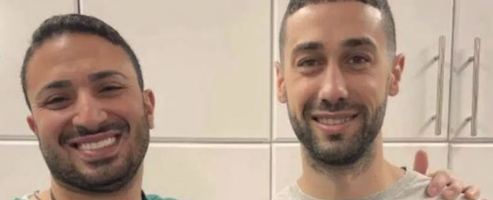 Two smiling men indoors, one in scrubs and the other holding a sign with overlaid text reading Always good to...