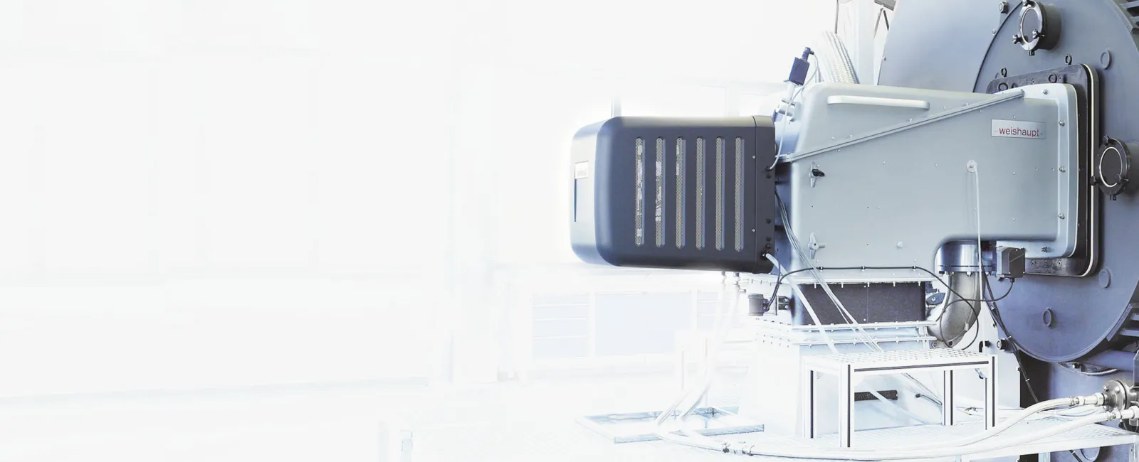 Close-up of industrial machinery with metallic components in a bright, white background environment