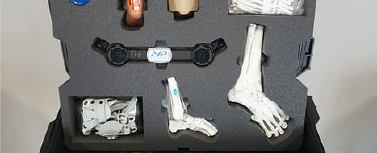 Medical kit displaying educational models and tools for understanding and treating clubfoot.