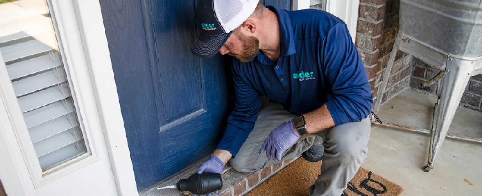 A technician installing a door component with a drill, showcasing home improvement services.
