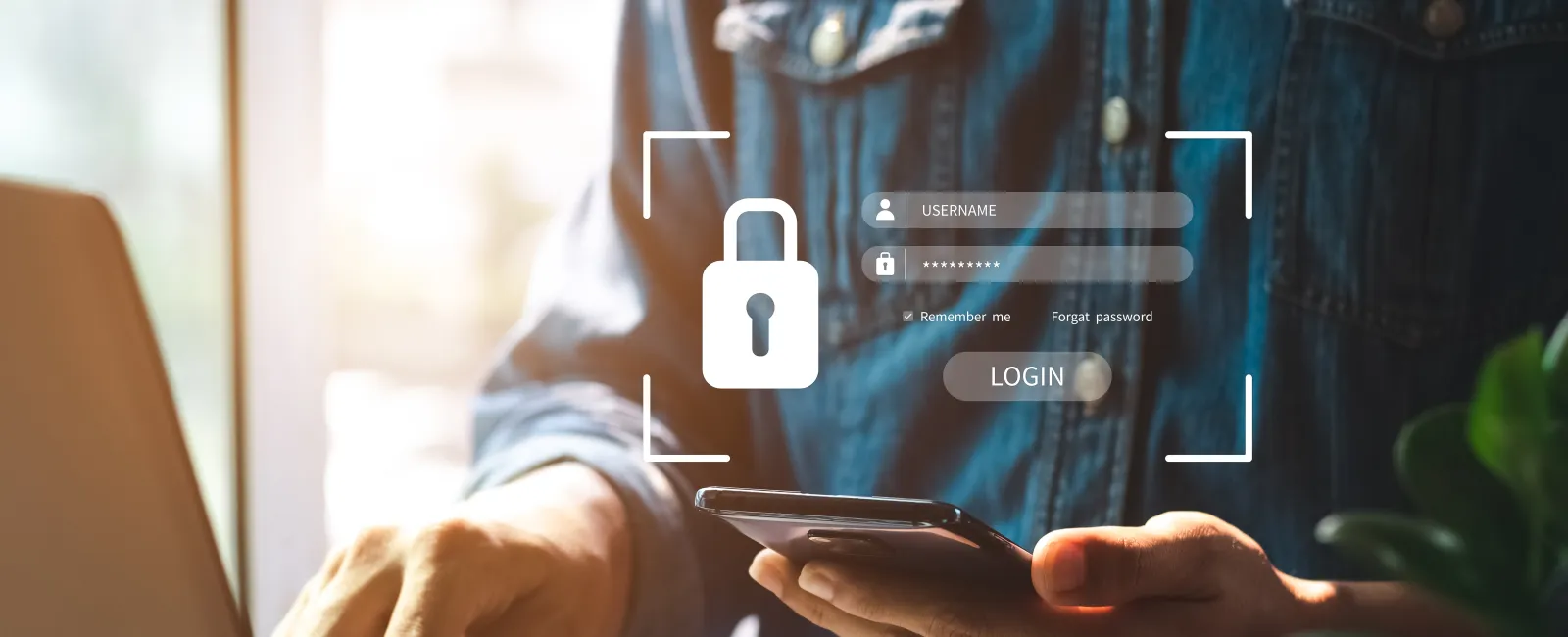 Person using smartphone and laptop with a digital lock icon and login screen overlay for secure access.
