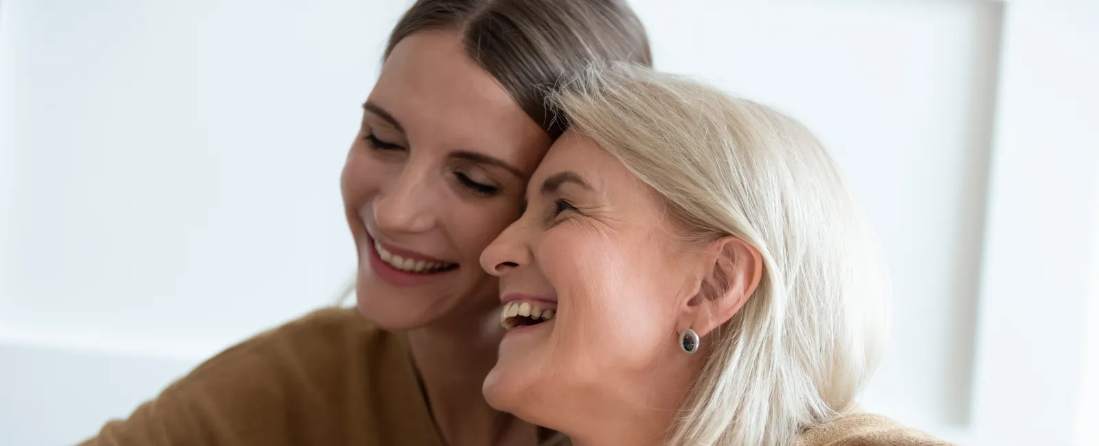 a woman kissing another woman's cheek