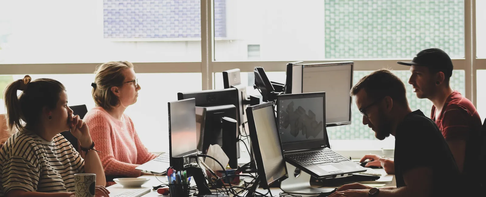 a group of people working on computers