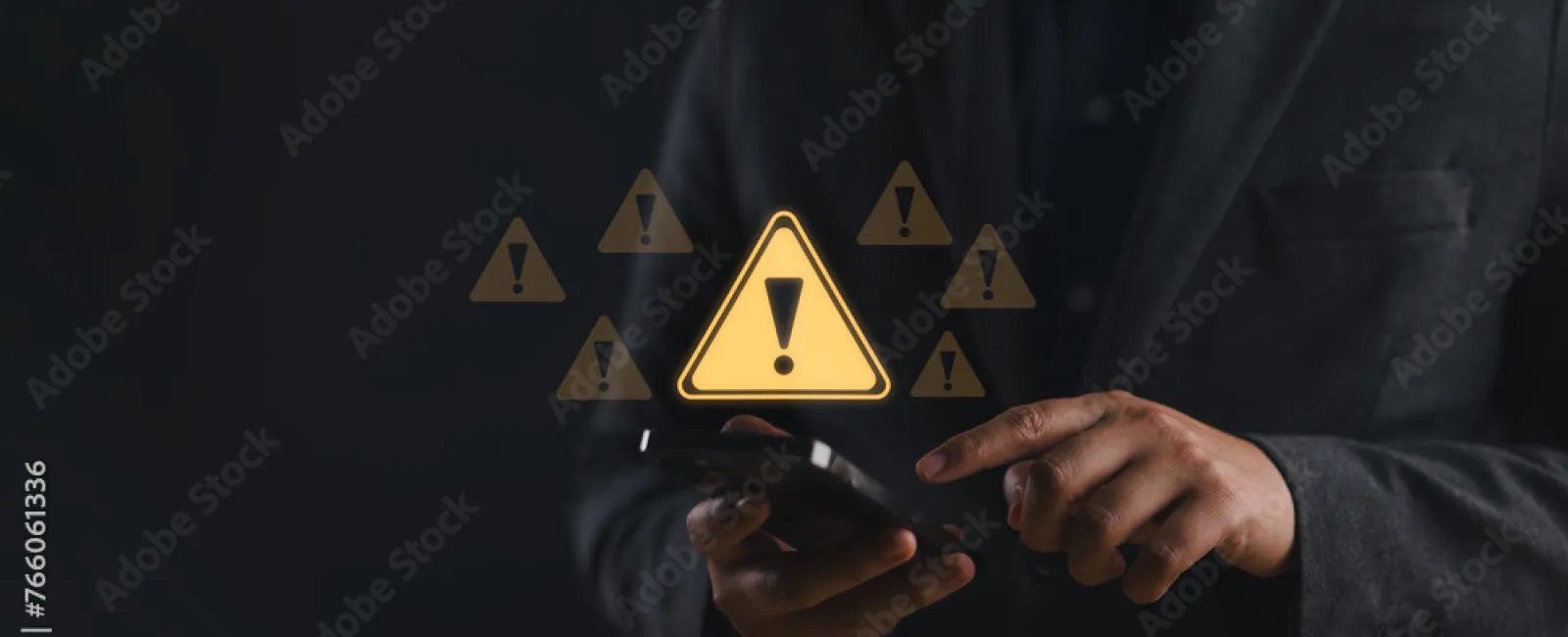 Businessman holding smartphone with multiple glowing yellow warning icons floating in dark background.