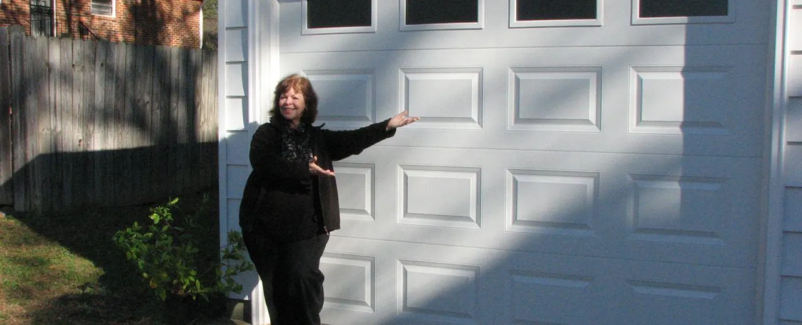 a man standing next to a white building