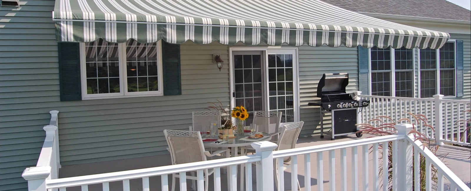 a house with a deck and a table and chairs