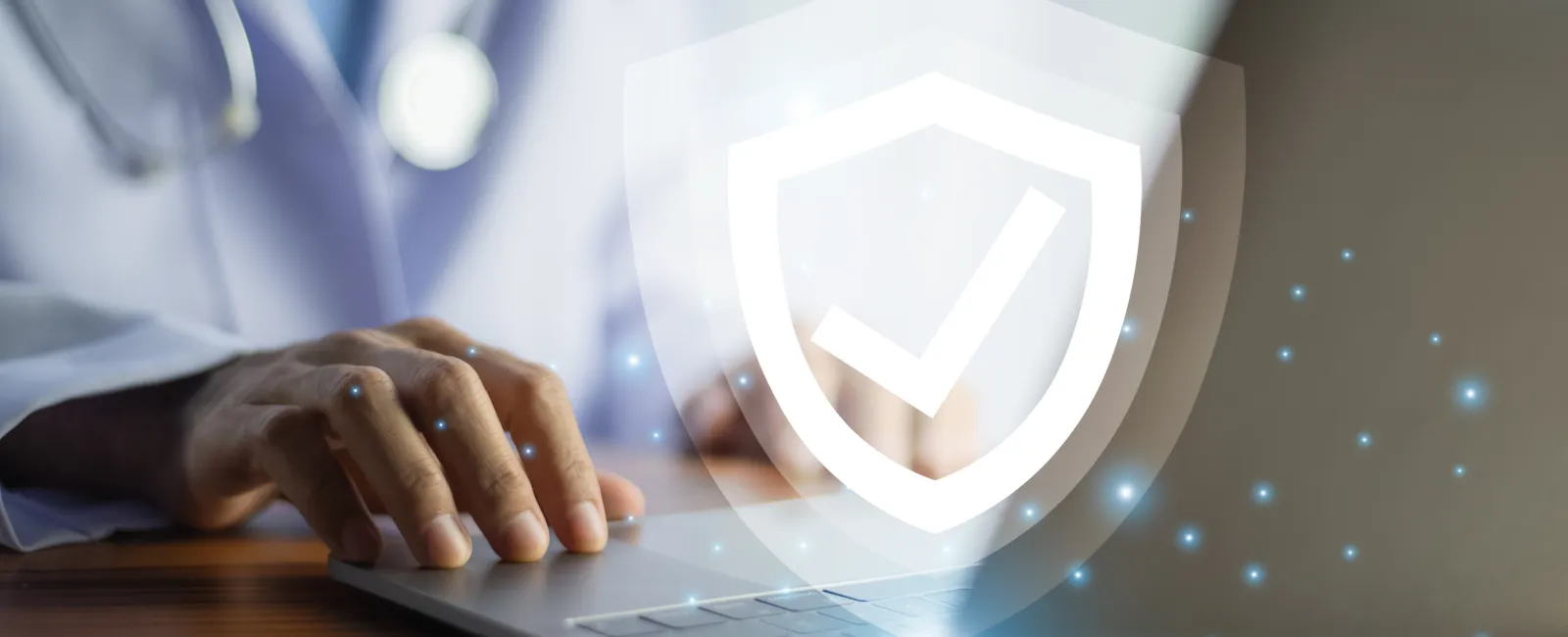Doctor using laptop with digital shield and checkmark symbolizing data security in healthcare technology.