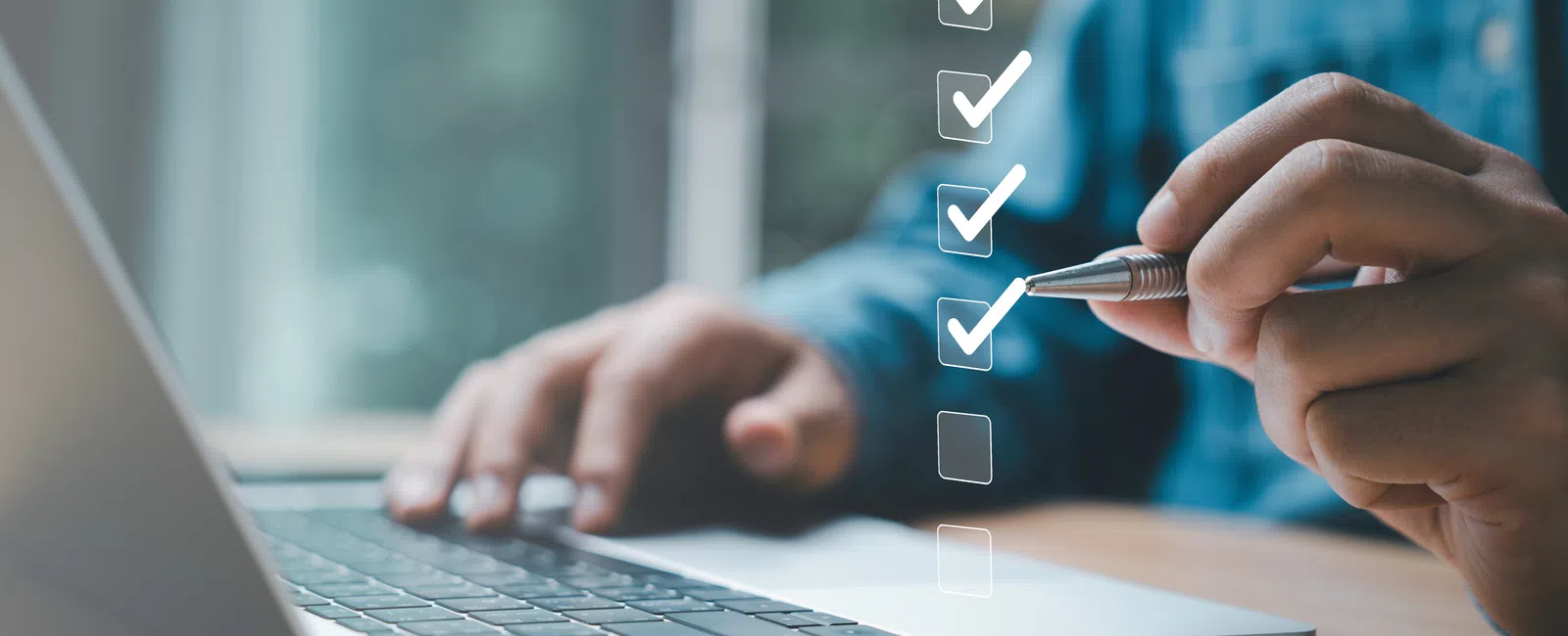 Person using laptop and pen to check off items on a digital checklist or task list on screen.