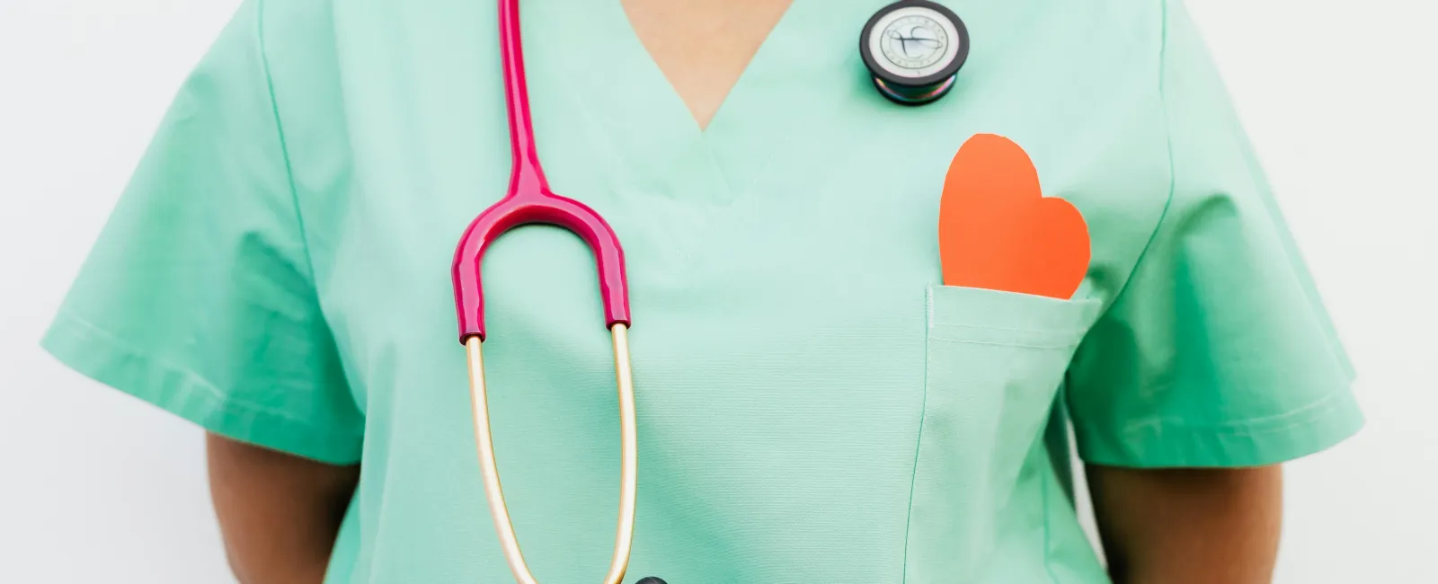 a person wearing a green shirt with a stethoscope around it