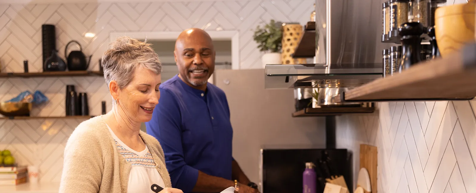 a man and a woman in a kitchen