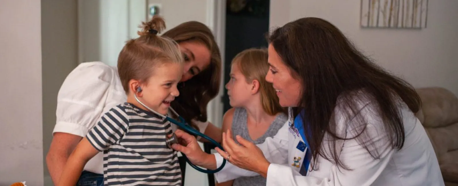 a person and kids playing with a toothbrush