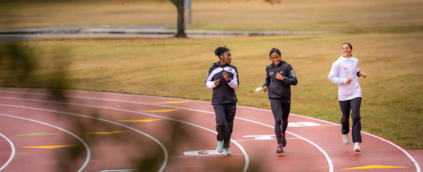 a group of people running on a track