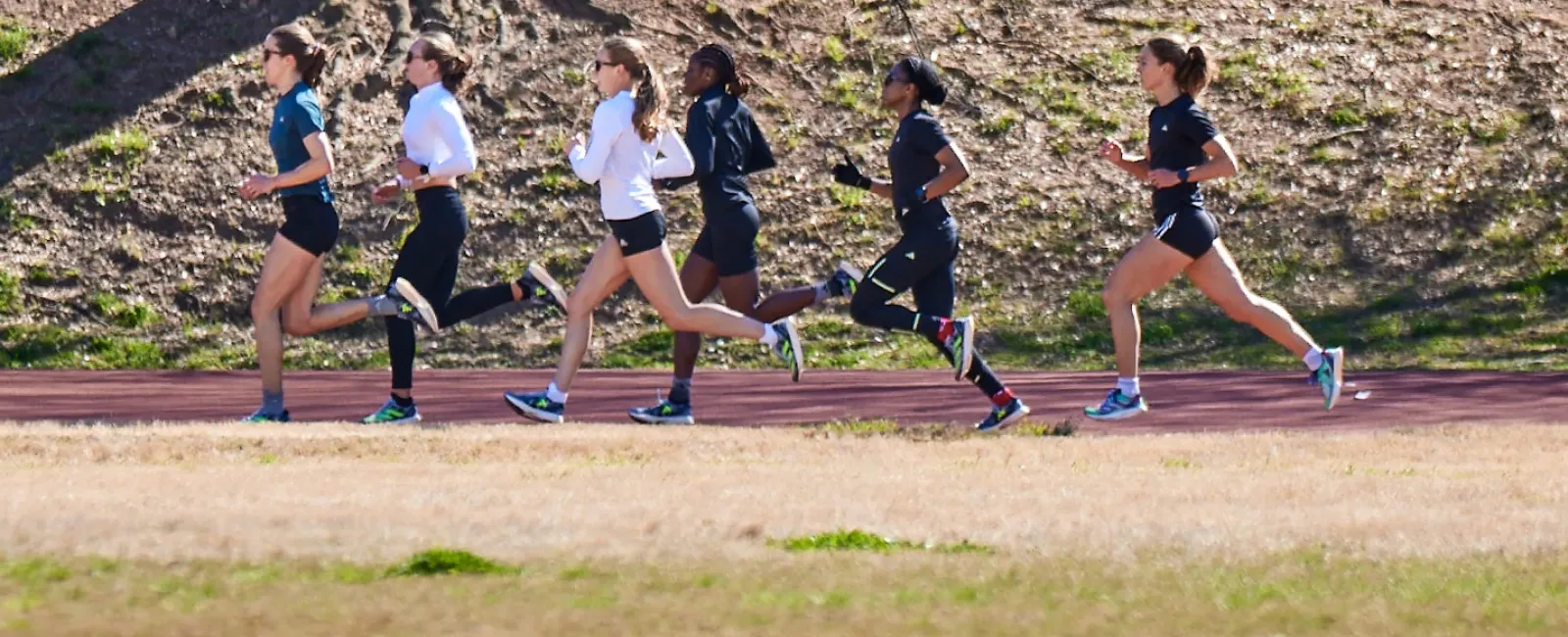 a group of people running on a track