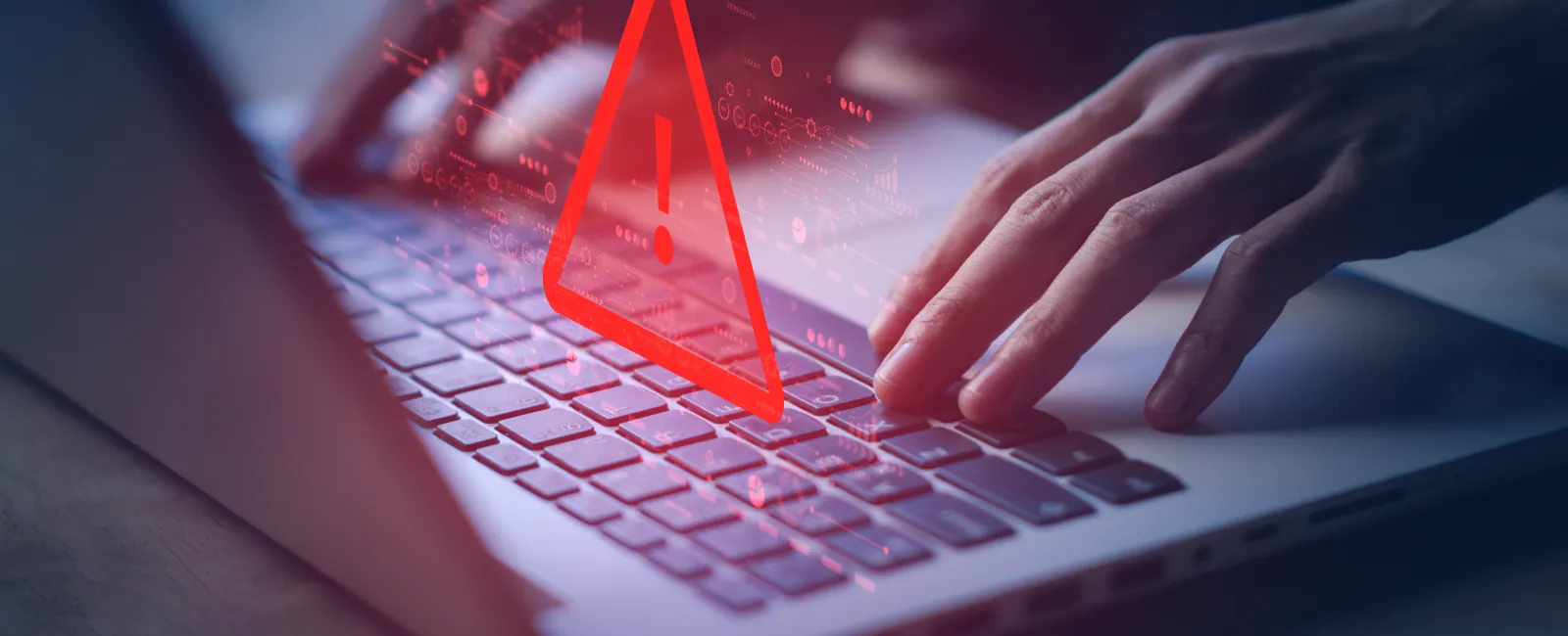 Hands typing on a laptop keyboard with a red warning alert symbol hovering above keys indicating a security or error issue.