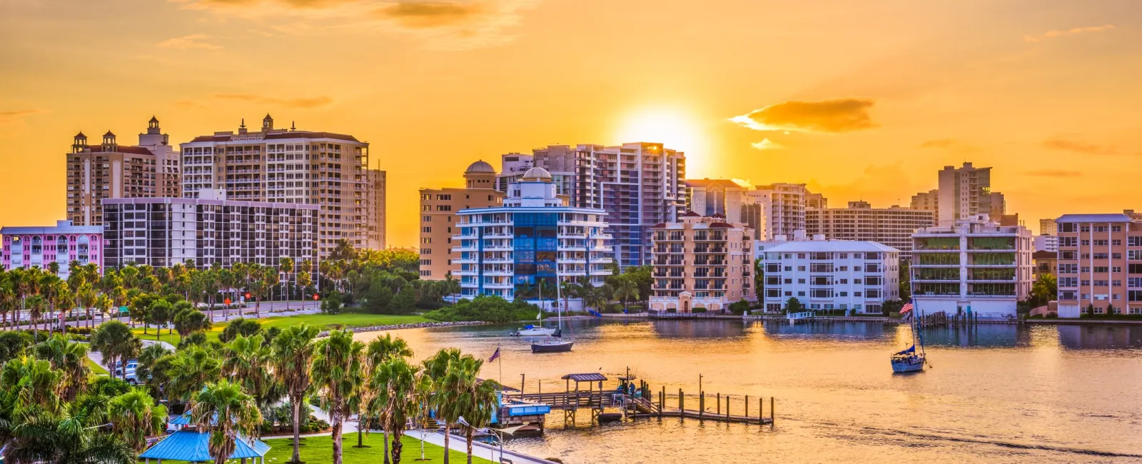 a beach with buildings and trees