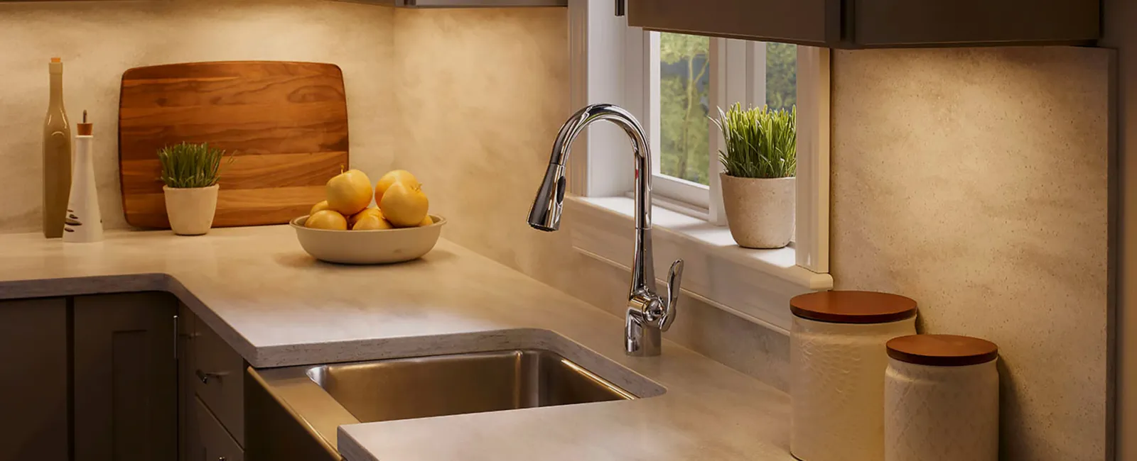 a kitchen with a sink and a bowl of fruit